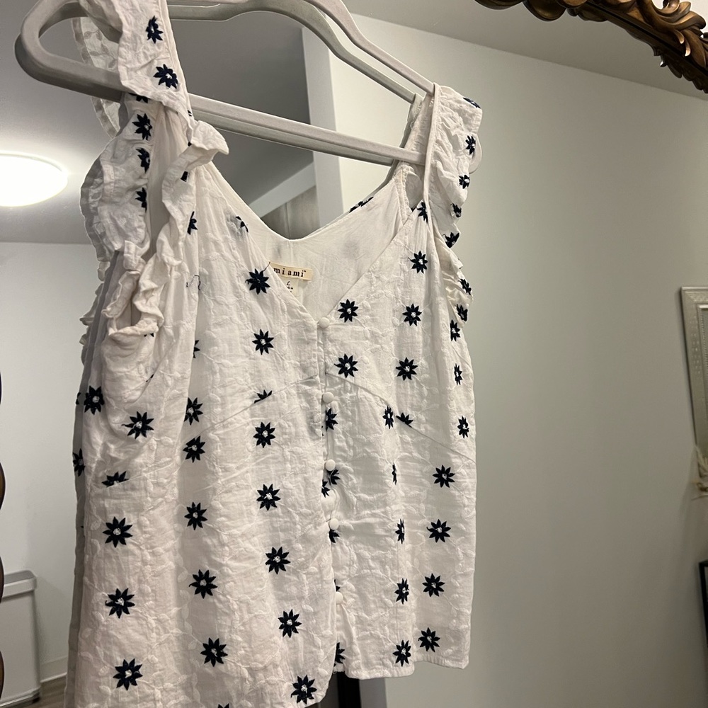 White ruffled tank top with navy flowers
